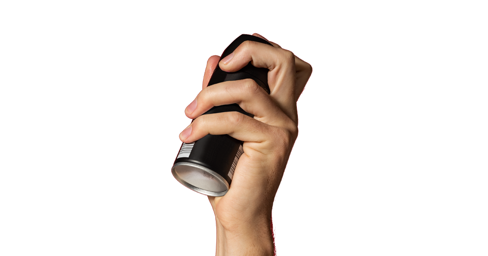 White hand holding a black aerosol can